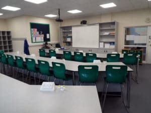 Green chairs in a classroom