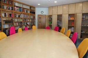 Colourful chairs around an oval table