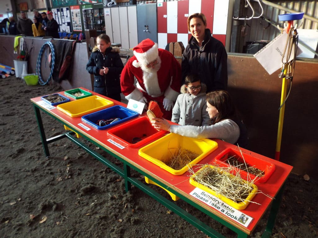 Adults and children using the sensory table