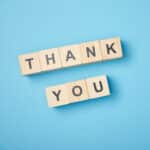 Top View Of Wooden Cubes With Thank You Words On Blue Background